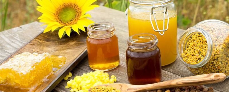 54612483 - various bee products placed on a wooden table